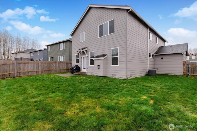 rear view of property with a fenced backyard, a lawn, and central air condition unit