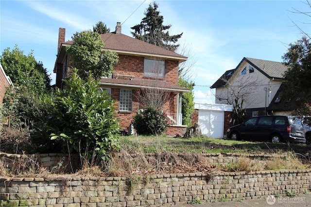 view of front facade featuring an outbuilding and brick siding