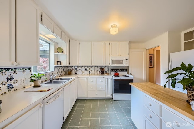 kitchen with white appliances, decorative backsplash, white cabinetry, open shelves, and a sink