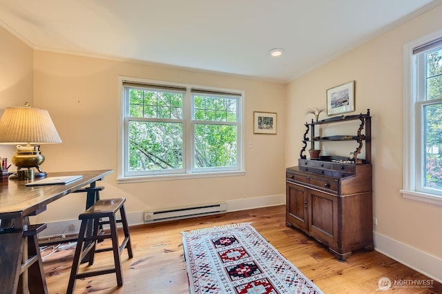 office space with ornamental molding, a baseboard radiator, light wood-type flooring, and baseboards