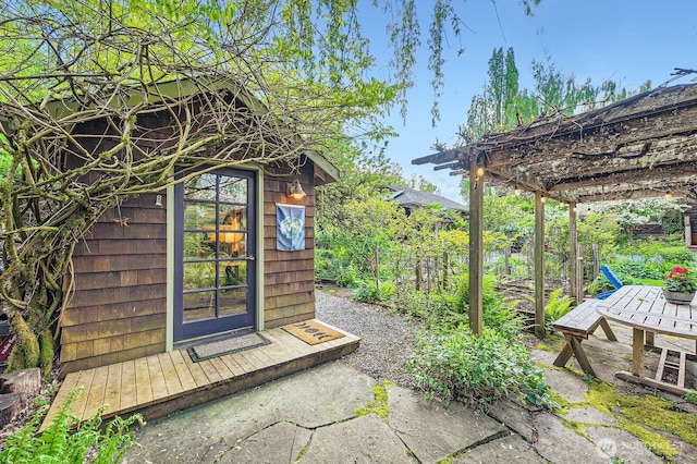 view of outbuilding featuring an outdoor structure and a pergola