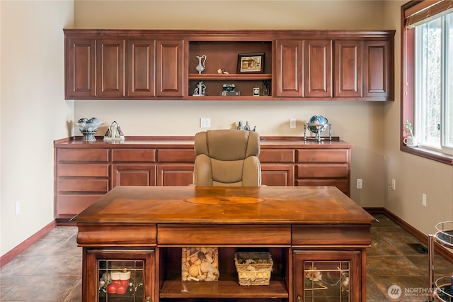 office area featuring dark tile patterned flooring and baseboards