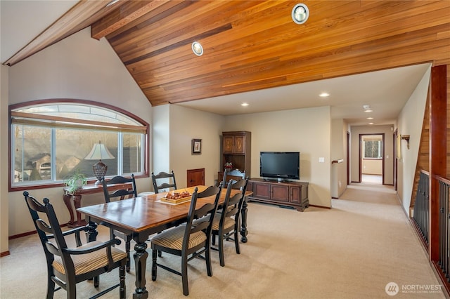 dining area featuring light carpet, recessed lighting, baseboards, and vaulted ceiling with beams