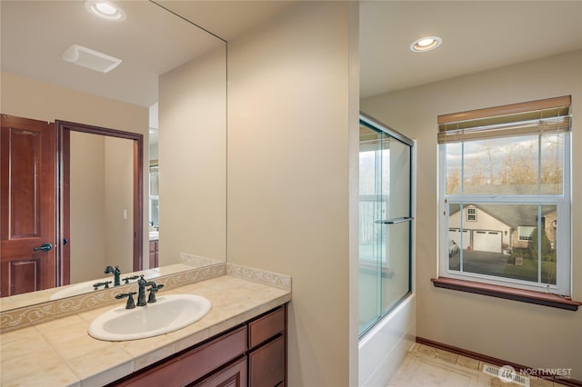 bathroom with recessed lighting, visible vents, vanity, and bath / shower combo with glass door