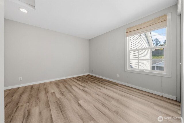 unfurnished room with recessed lighting, baseboards, and light wood finished floors