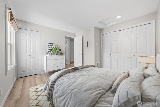 bedroom featuring light wood-style floors, attic access, recessed lighting, baseboards, and a closet