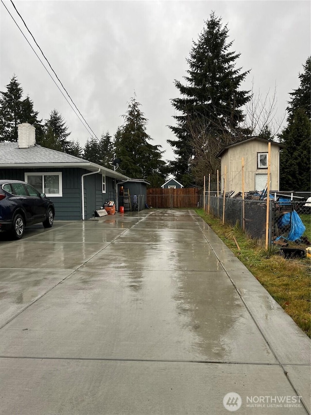 view of street featuring concrete driveway