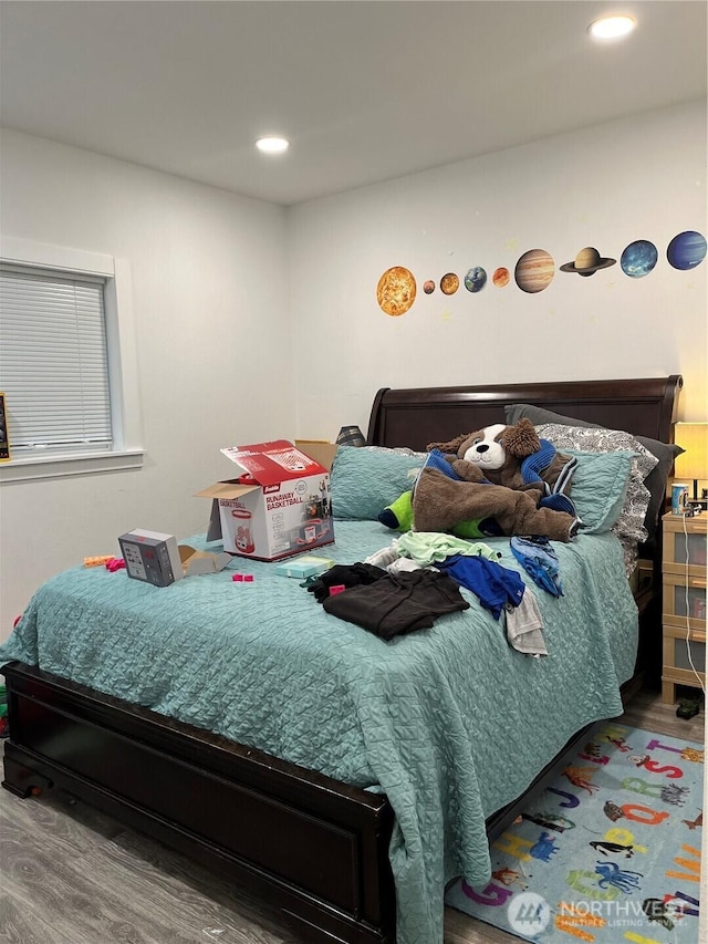 bedroom with recessed lighting and wood finished floors