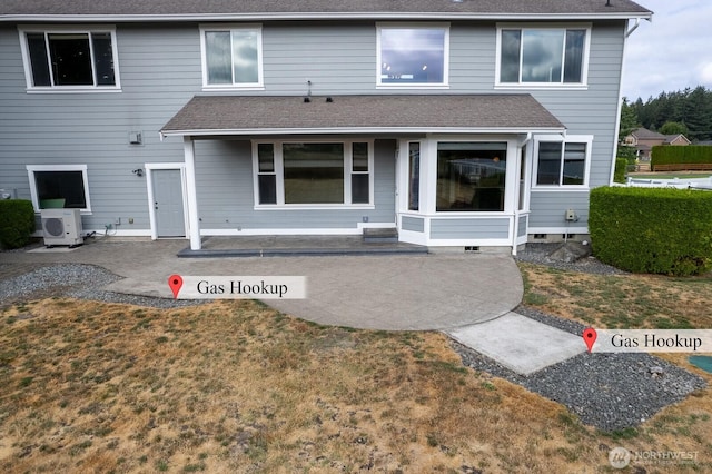 back of house featuring a patio area, a shingled roof, a lawn, and ac unit