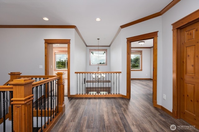 hallway featuring baseboards, wood finished floors, an inviting chandelier, an upstairs landing, and recessed lighting