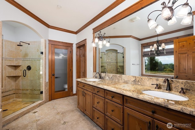 bathroom featuring crown molding, a notable chandelier, a sink, and a shower stall