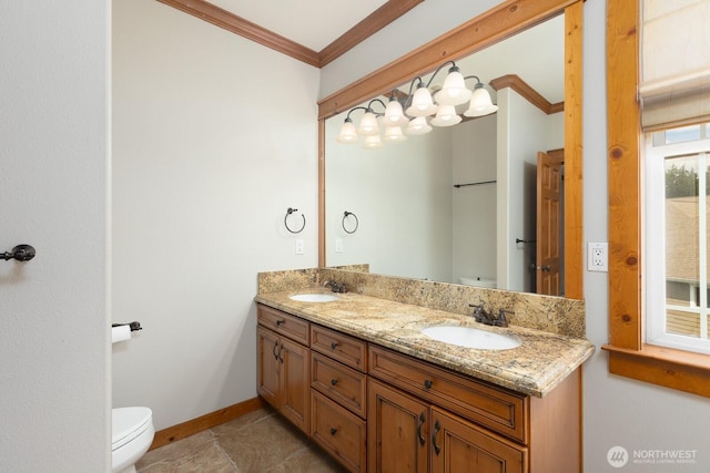 full bathroom with toilet, double vanity, ornamental molding, and a sink