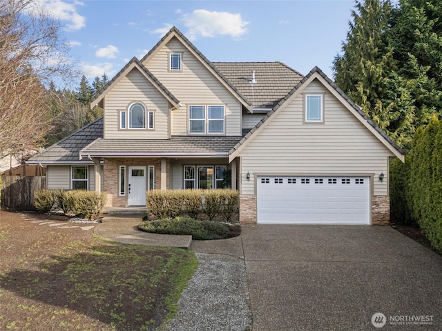 traditional-style home featuring driveway and stone siding