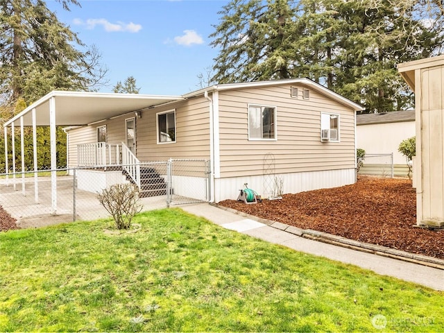 view of front of home with a carport, a gate, fence, and a front lawn