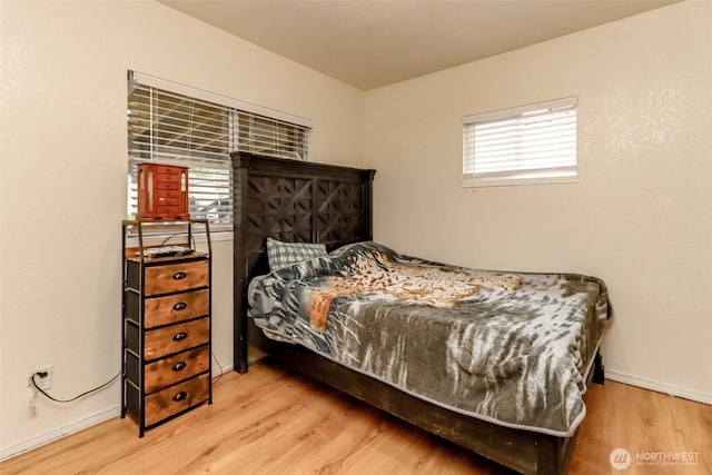 bedroom featuring baseboards and wood finished floors