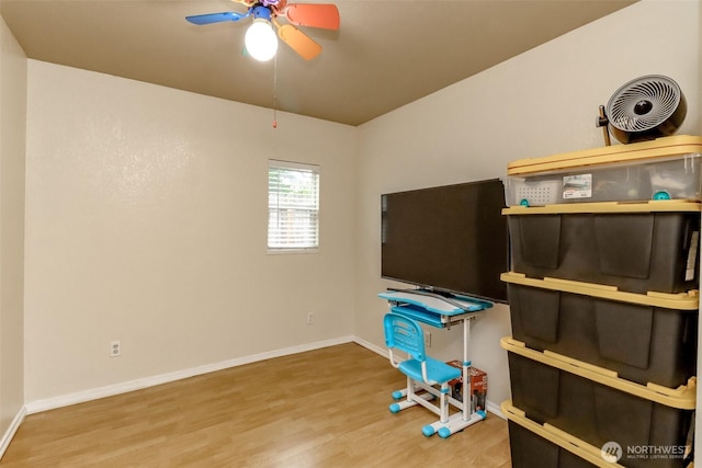 office featuring wood finished floors, a ceiling fan, and baseboards