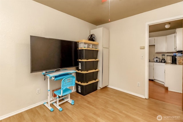 office area featuring light wood-style floors and baseboards