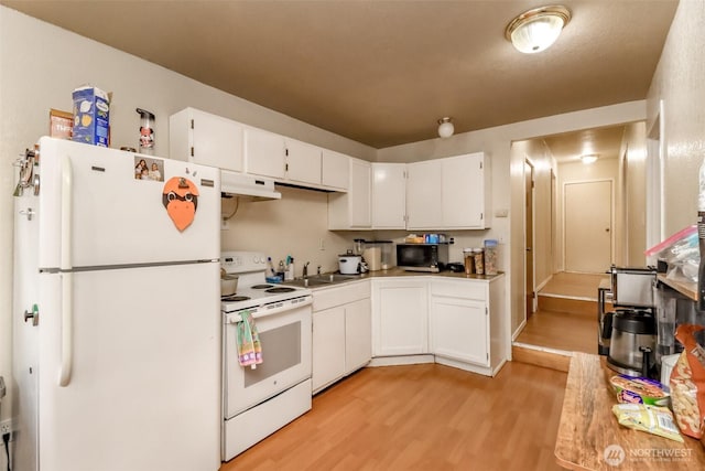 kitchen with white appliances, under cabinet range hood, white cabinets, and light wood finished floors