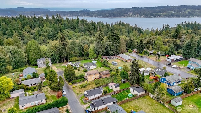 aerial view with a water view, a wooded view, and a residential view