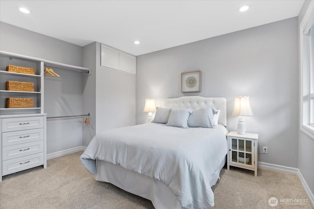 bedroom with light carpet, recessed lighting, and baseboards