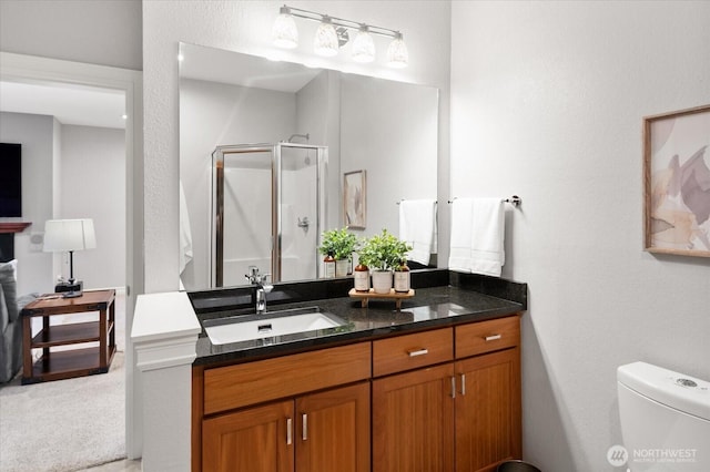 full bath with toilet, a shower stall, and vanity