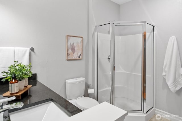 bathroom featuring a stall shower and a sink