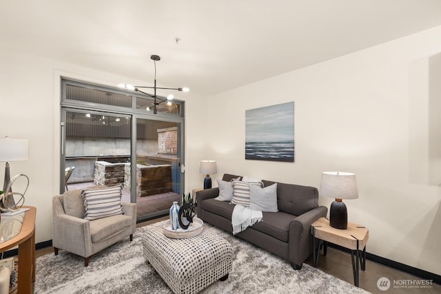 living room with baseboards and a chandelier