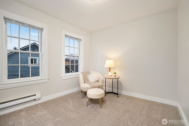 living area with carpet floors, baseboards, and a baseboard heating unit