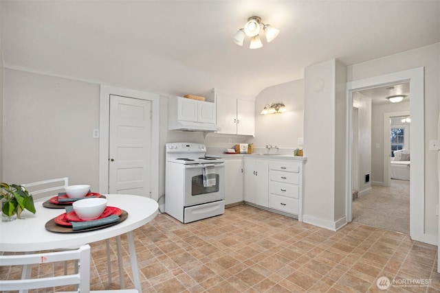 kitchen featuring white range with electric cooktop, white cabinets, lofted ceiling, light countertops, and a sink