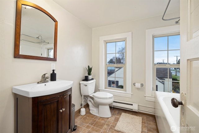 bathroom featuring toilet, a baseboard radiator, vanity, and a healthy amount of sunlight