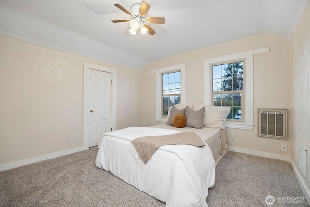 bedroom featuring baseboards, ceiling fan, heating unit, carpet, and vaulted ceiling