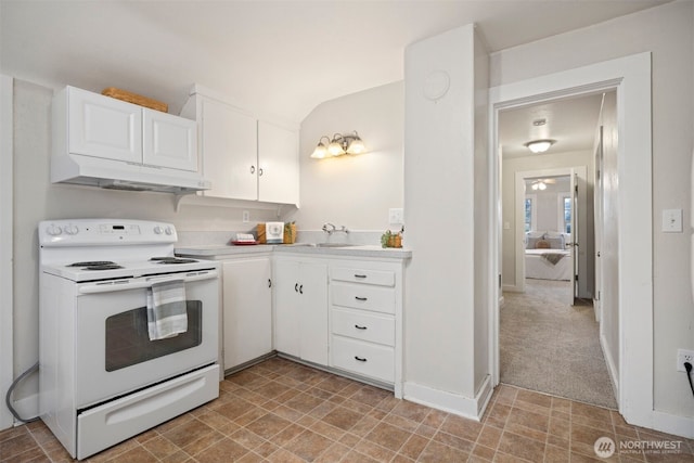 kitchen featuring white cabinets, light colored carpet, light countertops, white electric range, and under cabinet range hood