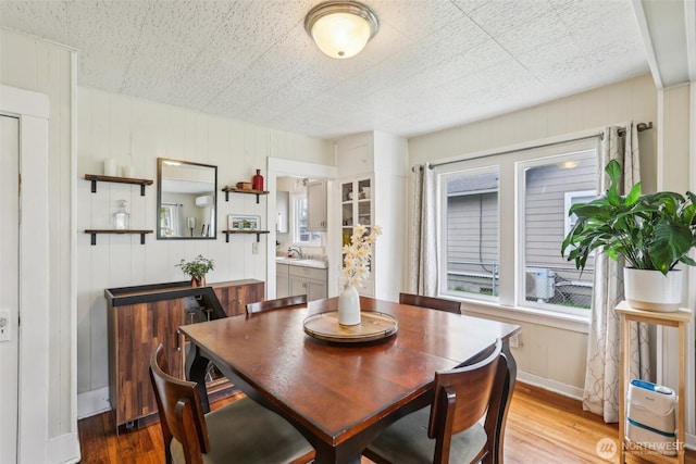 dining room with baseboards and light wood finished floors