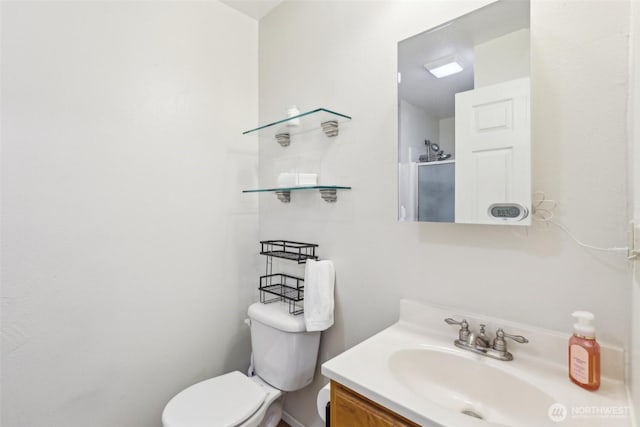 bathroom featuring vanity and toilet