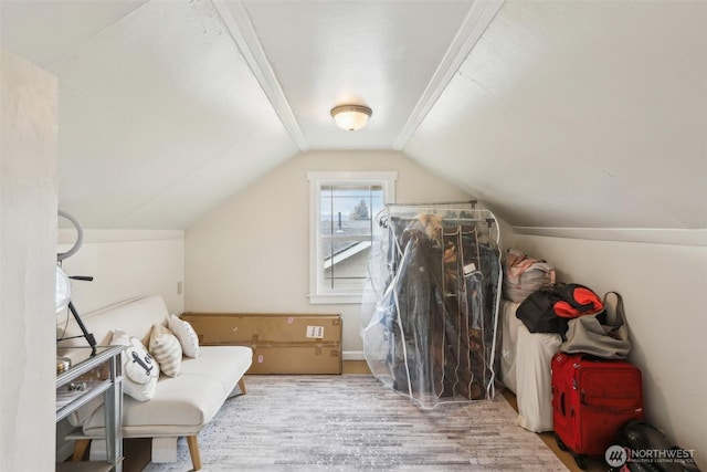 additional living space featuring vaulted ceiling and wood finished floors