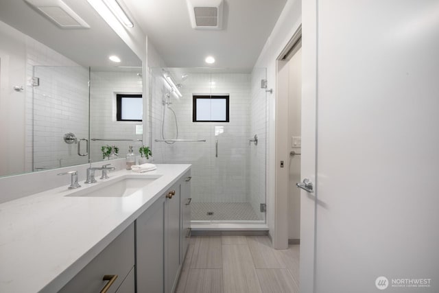 full bath with recessed lighting, visible vents, a shower stall, and vanity