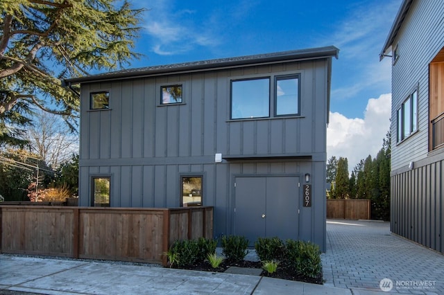 view of home's exterior with fence and board and batten siding