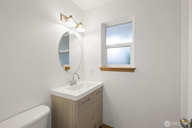 bathroom with toilet and vanity