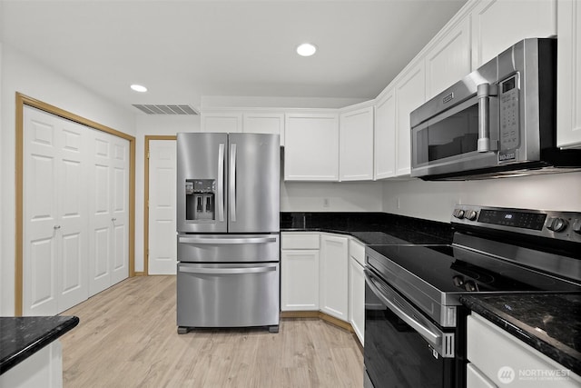 kitchen featuring visible vents, white cabinets, and appliances with stainless steel finishes