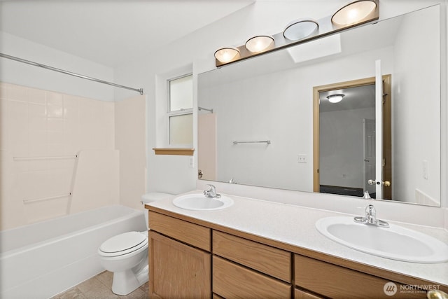 bathroom featuring double vanity, shower / bath combination, toilet, and a sink