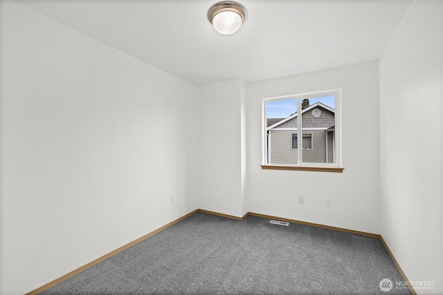 carpeted empty room featuring visible vents and baseboards