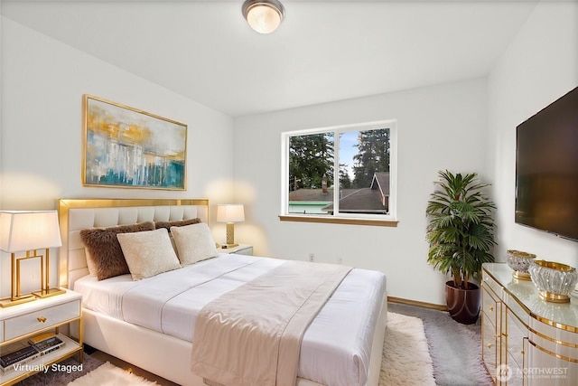 carpeted bedroom featuring baseboards