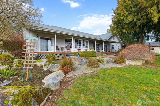 exterior space featuring covered porch and a lawn