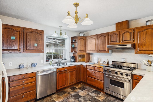 kitchen featuring brown cabinetry, appliances with stainless steel finishes, light countertops, under cabinet range hood, and a sink