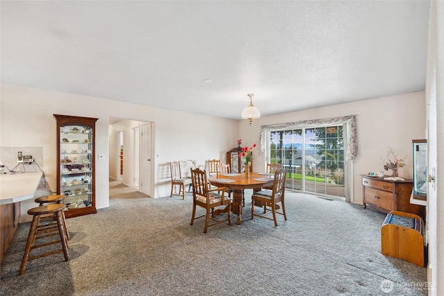 dining space with carpet flooring