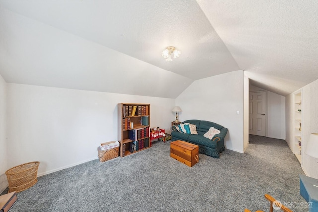 living area featuring lofted ceiling, a textured ceiling, and carpet