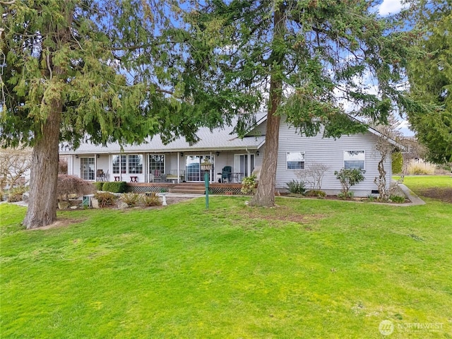 back of property with a porch and a lawn