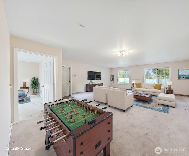 recreation room featuring light colored carpet