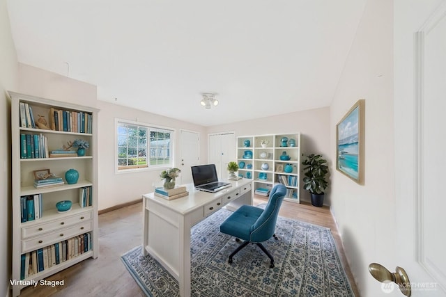 home office with light wood-style floors and baseboards