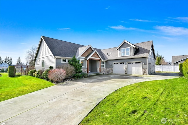 view of front of house with fence, stone siding, driveway, roof with shingles, and a front lawn